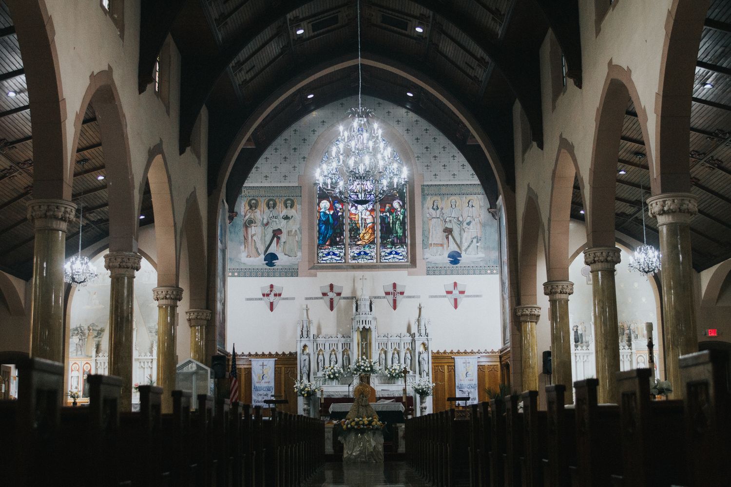 The welcoming interior of a Catholic church with altar and stained glass